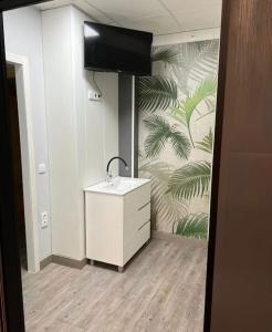 a bathroom with a sink and a wall with a mural at Guadiana Loft Experience Nadra in Badajoz