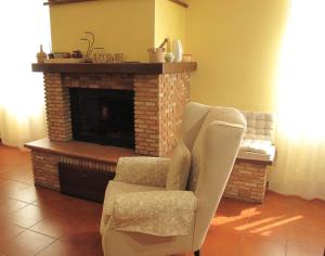 a living room with a chair and a fireplace at La Casa Dei Nonni in Massa Martana +4 photos