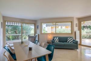 a living room with a table and a couch at TANIT Piscine, 6 couchages, Parking in Antibes