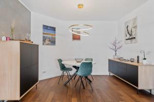 a dining room with a table and chairs at Modern Lux Apartment with Balcony in Luxembourg in Luxembourg