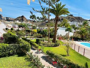 a view of a resort with a swimming pool and palm trees at Playa del Cura - Beachside Retreat in Playa del Cura
