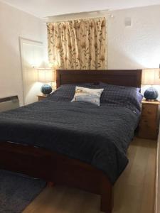 a bedroom with a bed with a black comforter at 105 Seatown in Cullen