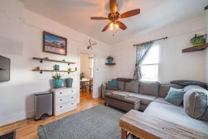 a living room with a couch and a ceiling fan at Eastside Bungalow in Livingston