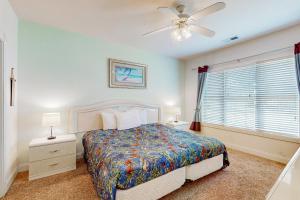 a bedroom with a bed and a ceiling fan at Oasis on the Greens in Myrtle Beach