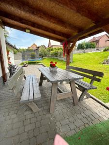 a picnic table and two benches on a patio at Agroturystyka ‚U Misia’ in Krzywopłoty