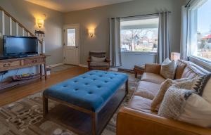 a living room with a couch and a tv at 7th Street Bungalow in Livingston