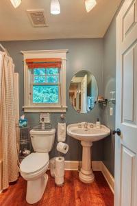a bathroom with a toilet and a sink and a mirror at The Red House Homestead in Livingston +24 photos