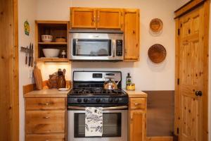 a kitchen with a stove and a microwave at West Clark Getaway in Livingston