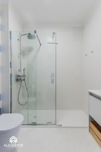 a shower with a glass door in a bathroom at São Lourenço Apt - Amazing terrace with Sea View in Ericeira