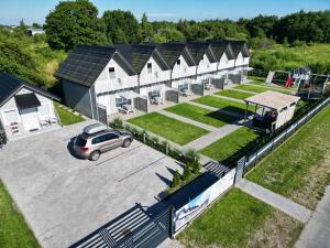 an overhead view of a building with a car in a parking lot at Westbeach House in Grzybowo
