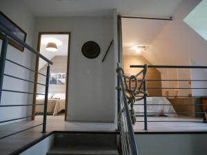 a staircase leading to a bedroom in a house at Chalet chaleureux à Marigny-l'Église avec vue sur lac et montagne in Marigny-lʼÉglise