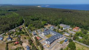 an aerial view of a large building in the woods at Jantar Resort Apartament in Jantar