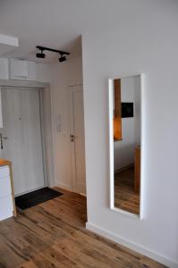 an empty room with a mirror and a hallway at Jantar Resort Apartament in Jantar
