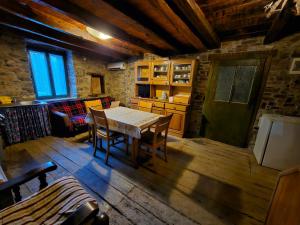 a kitchen and dining room with a table and chairs at Apartment Matijašić in Ukotići