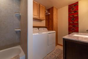a small bathroom with a washing machine and a sink at Garden House in Livingston +22 photos