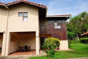 a house with a patio in front of it at Angels Mar Villa Hermosa 2b2b European Villa in Playa Hermosa
