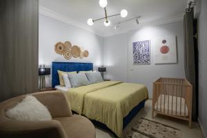 a bedroom with a bed and a chair at Skyline Premium Properties in Alexandria
