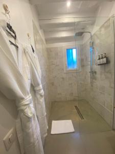 a bathroom with a shower with a glass door at Hebe la villa in Cogolin