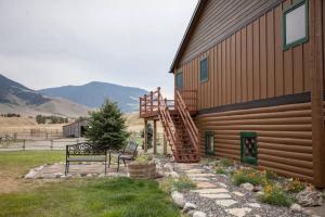 a bench sitting in front of a house at Rancho Deluxe Lodge in Livingston