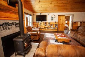a living room with a wood stove in a cabin at Rancho Deluxe Lodge in Livingston