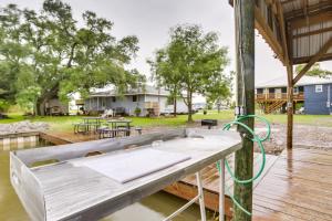 a picnic table on a deck with a house in the background at Dularge Grand Villa - Steps to Marina and Fishing! in Theriot