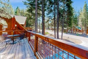 a wooden deck with a table and chairs on it at Oslo Oasis in Truckee