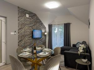 a living room with a table and a couch at Heaven Apartment in Hajdúszoboszló