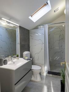 a bathroom with a sink and a toilet and a shower at Heaven Apartment in Hajdúszoboszló