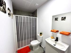 a bathroom with a shower and a toilet and a sink at Apartamento Naranja in Bolnuevo +42 photos