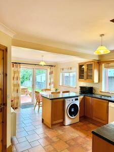 a kitchen with a washer and dryer at No 10 Ard Na Mara in Dingle +19 photos