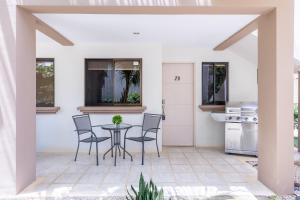 a patio with a table and chairs at Pacific Sunset Ground Unit Condo Across The Beach in Coco