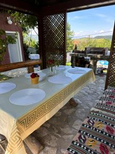a table with plates on it on a patio at Villa Solis Sarajevo Private Pool Jacuzzi in Sarajevo