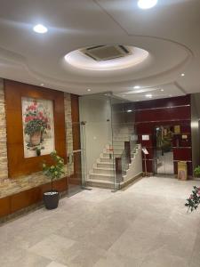 a lobby with a staircase in a building at أول سويت للشقق المخدومة in Riyadh