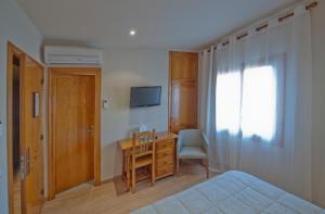 A television and/or entertainment centre at Hotel Jardí Apartaments