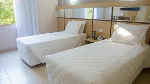 Postel nebo postele na pokoji v ubytování SJ Tour - San Juan Foz do Iguaçu