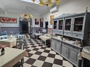 a restaurant with tables and chairs in a room at Hostal Sevillana Costa in Chipiona +35 photos