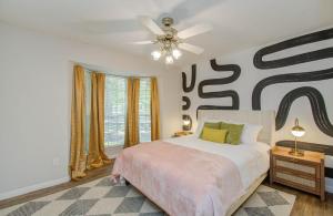 a bedroom with a bed and a ceiling fan at 4BD - Pool & Movie Theater - Lake Conroe Nearby in Conroe +39 photos