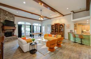 a living room with a couch and a table at 4BD - Pool & Movie Theater - Lake Conroe Nearby in Conroe