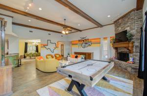 a living room with a ping pong table in it at 4BD - Pool & Movie Theater - Lake Conroe Nearby in Conroe