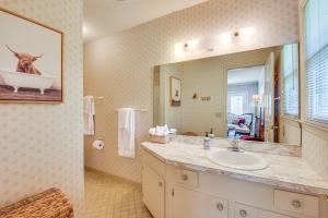 a bathroom with a sink and a large mirror at Spacious Home with Porch, 4 Mi to Downtown Clemson! in Central +23 photos