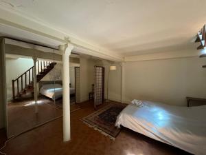 a bedroom with a bed and a staircase in it at 2 chambres 9mn Arc de Triomphe in Neuilly-sur-Seine