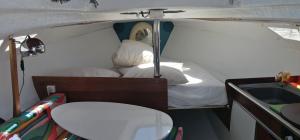 a small room with a bed and a sink at 70's Tiny Boat in Lisbon