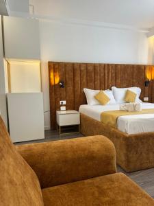 a hotel room with two beds and a chair at HOTEL BAR RESTORANT YLLI in Shëngjin