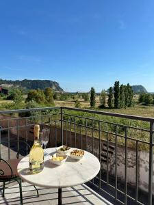 a table with a bottle of wine and glasses on a balcony at B&B Paura in Naples