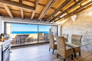 a kitchen and dining room with a view of the ocean at Panoramic by Unik Vacation in Tarragona