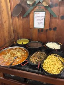 a group of trays of food on a table at Hotel Fazenda São Moritz in Teresópolis