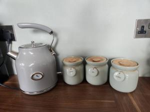 a group of four coffee cups sitting on a table at Luxury 1 Bed Coach House in Huddersfield