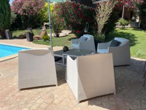 a patio with a table and chairs next to a pool at Studio Le Pitchoun in Pernes-les-Fontaines