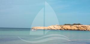 a view of the ocean with a boat in the water at Marina Cap Monastir- Appart'Hôtel in Monastir