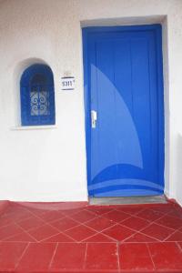 a blue door on the side of a building at Marina Cap Monastir- Appart'Hôtel in Monastir